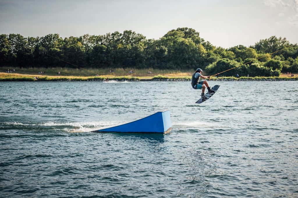 Rider carving a fan of spray on dark water